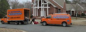 Water Damage and Mold Removal Vehicles At Job Site