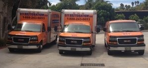 Water Damage and Mold Removal Vehicles At Commercial Job Site